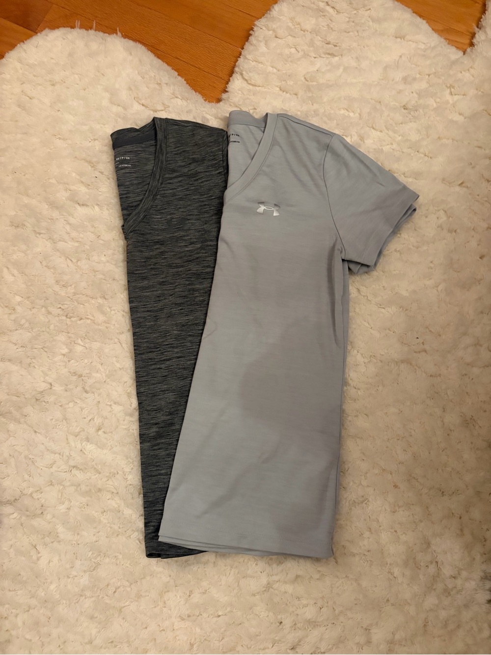 Two Under Armour women’s Light and dark Gray Performance V-Neck Shirts.